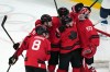 Canada goalkeeper Jordan Binnington (50) is congratulated after Canada's 3-2 win over Finland in a men's ice hockey semifinal game at the 2026 Winter Olympics in Milan, Italy, Friday, Feb. 20, 2026. (AP Photo/Carolyn Kaster)
