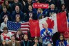 Spectators cheer on the United States and Canada during the men's ice hockey gold medal game at the 2026 Winter Olympics, in Milan, Italy, Sunday, Feb. 22, 2026. (AP Photo/Luca Bruno)