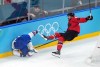 Canada's Tom Wilson (43) checks United States' Dylan Larkin (21) during the first period of the men's gold medal hockey game at the 2026 Winter Olympics, in Milan, on Sunday, Feb. 22, 2026. THE CANADIAN PRESS/Darryl Dyck
