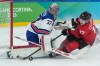 United States' Connor Hellebuyck (37) stops a shot attempt by Canada's Macklin Celebrini (17) during the third period of a men's ice hockey gold medal game between Canada and the United States at the 2026 Winter Olympics, in Milan, Italy, Sunday, Feb. 22, 2026. (AP Photo/Petr David Josek)