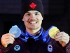 Canadian Mikael Kingsbury from Deux-Montagnes, Que., holds up his silver and gold medals he won at the Milano Cortina 2026 Winter Olympic Games in Livigno, Italy on Monday, Feb. 16, 2026. Kingsbury won silver in the men's moguls and gold in the men's dual moguls. THE CANADIAN PRESS/Sean Kilpatrick
