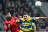 AC Milan's Ruben Loftus-Cheek, left, fights for the bass with Parma's Emanuele Valeri during the Italian Serie A soccer match between AC Milan and Parma in Milan, Italy, Sunday, Feb. 22 , 2025. (Spada/LaPresse via AP)