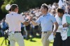 Jacob Bridgeman, left, shakes hands with Rory McIlroy, from Northern Ireland, after winning the Genesis Invitational golf tournament at Riviera Country Club, Sunday, Feb. 22, 2026, in the Pacific Palisades area of Los Angeles. (AP Photo/Caroline Brehman)