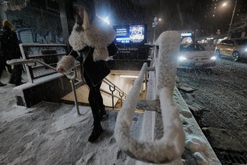 A passenger exits a subway station as snow falls in the Alphabet City neighborhood of New York, Sunday evening, Feb. 22, 2026. (AP Photo/Patrick Sison)