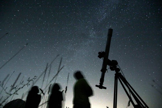 People look up to the sky from an observatory near Avren, Bulgaria. (Petar Petrov / The Associated Press files)