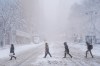 Pedestrians cross 42nd Street near Bryant Park during a snow storm, Monday, Feb. 23, 2026, in New York. (AP Photo/Seth Wenig)