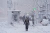 A pedestrian walks along 42nd Street near Bryant Park during a snow storm, Monday, Feb. 23, 2026, in New York. (AP Photo/Seth Wenig)