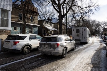 Police vehicles are shown outside the scene of a shooting at a home in Winnipeg on Monday, Nov. 27, 2023. Officers were called shortly after 4 a.m. to a home where they found five people wounded. THE CANADIAN PRESS/Aaron Vincent Elkaim