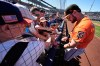 San Francisco Giants' Bryce Eldridge signs autographs before a spring training baseball game against the Seattle Mariners, Saturday, Feb. 21, 2026, in Peoria, Ariz. (AP Photo/Charlie Riedel)
