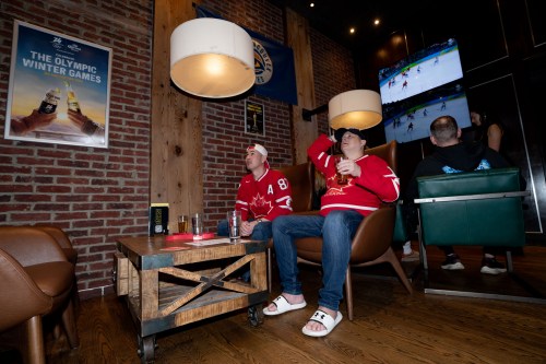 Fans react during a watch party of the men's Olympic gold medal hockey game between Canada and the United States, in Vancouver, on Sunday, Feb. 22, 2026. THE CANADIAN PRESS/Ethan Cairns