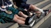 FILE - Scottish soccer fans wearing kilts sit on the steps in Trafalgar Square after attending a service to mark Armistice Day in London, Friday, Nov. 11, 2016. (AP Photo/Kirsty Wigglesworth, File)