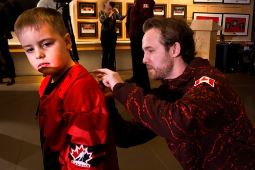 Team captain Tyler McGregor signs the jersey for Caleb Flanigan, five-years-old, after Hockey Canada announced the roster for the Canadian paralympic team in Calgary on Tues., Jan. 20, 2026. THE CANADIAN PRESS/Larry MacDougal