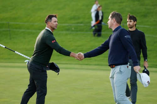 Adam Scott, from Australia, left, shakes hands with Ryan Gerard after finishing the first round of the Genesis Invitational golf tournament at Riviera Country Club, Thursday, Feb. 19, 2026, in the Pacific Palisades area of Los Angeles. (AP Photo/Caroline Brehman)