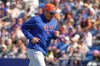 New York Mets manager Carlos Mendoza jogs back from the mound after making a pitching change during the fourth inning of a spring training baseball game Tuesday, Feb. 24, 2026, in Port St. Lucie, Fla. (AP Photo/Jeff Roberson)