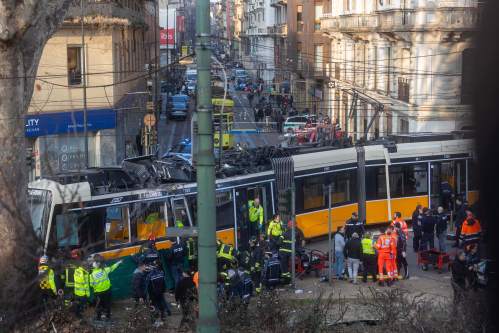 Rescuers and police officers work at the scene of a derailment on Line 9 in Milan, Italy, Friday, Feb. 27, 2026. (Stefano Porta/LaPresse via AP)