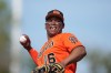 San Francisco Giants' Rafael Devers smiles as he tosses a ball into the crowd during the fourth inning of a spring training baseball game against the Athletics Monday, Feb. 23, 2026, in Scottsdale, Ariz. (AP Photo/Ross D. Franklin)