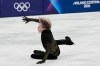 FILE - Ilia Malinin of the United States falls during the men's free skate program in figure skating at the Winter Olympics, in Milan, Italy, Feb. 13, 2026. (AP Photo/Natacha Pisarenko, File)