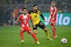 Dortmund's Emre Can and Bayern Munich's Luis Díaz, left, in action during the Bundesliga soccer match between Borussia Dortmund and FC Bayern Munich in Dortmund, Germany, Saturday Feb. 28, 2026. (David Inderlied/dpa via AP)