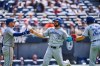 Toronto Blue Jays' Jonatan Clase, center, is greeted by Myles Straw, left, and Ernie Clement (22) after scoring in the ninth inning of a baseball game against the Cleveland Guardians in Cleveland, Thursday, June 26, 2025. (AP Photo/Sue Ogrocki)