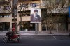 A motorcycle drives past a picture of the late Iranian Supreme Leader Ayatollah Ali Khamenei along an empty street in Tehran, Iran, Sunday, March 1, 2026, following the confirmed death of Khamenei in U.S. and Israeli strikes. (AP Photo/Vahid Salemi)