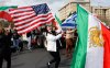 Karla Mohtashemi, center, celebrates as Voice of Iran hosts a car rally in Bellevue, Wash., on Saturday, Feb. 28, 2026, in response to the U.S. bombing of Iran. (Karen Ducey/The Seattle Times via AP)