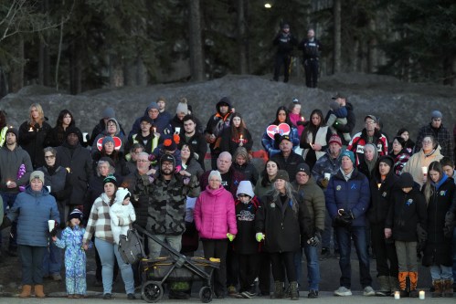 People attend a vigil for the victims of a mass shooting, in Tumbler Ridge, B.C., Friday, Feb. 13, 2026. THE CANADIAN PRESS/Christinne Muschi