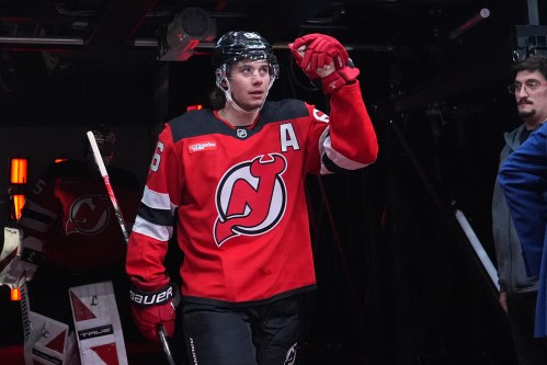 New Jersey Devils' Jack Hughes (86) walks toward the ice to warm up before an NHL hockey game against the Buffalo Sabres Wednesday, Feb. 25, 2026, in Newark, N.J. (AP Photo/Frank Franklin II)