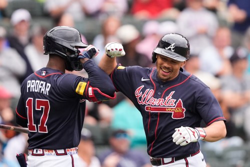 Atlanta Braves Drake Baldwin is greeted by Jurickson Profar after hitting a solo home run in the third inning of a spring training baseball game against the Minnesota Twins in North Port, Fla., Sunday, Feb. 22, 2026. (AP Photo/Gerald Herbert)