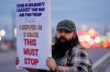 Army veteran Christopher William McFarland protests the war in Iran on Monday, March 2, 2026, in Clarksville, Tenn. (AP Photo/George Walker IV)