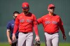 Boston Red Sox second baseman Brendan Rodgers (5) is tended to by a team trainer and manager Alex Cora (13) after being injured in the fourth inning of a spring training baseball game against the Minnesota Twins in Fort Myers, Fla., Wednesday, Feb. 25, 2026. (AP Photo/Gerald Herbert)