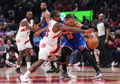Toronto Raptors' Jamal Shead (left) battles for the ball with New York Knicks' Jalen Brunson (11) during first half NBA basketball action in Toronto on Tuesday, March 3, 2026. THE CANADIAN PRESS/Nathan Denette
