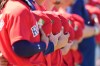 Boston Red Sox players hold their hats to their hearts for the national anthem before a spring training baseball game against the Minnesota Twins in Fort Myers, Fla., Wednesday, Feb. 25, 2026. (AP Photo/Gerald Herbert)