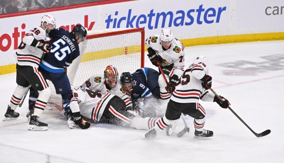 Chicago Blackhawks' Alex Vlasic (72) clears the puck to Ilya Mikheyev (95) after Winnipeg Jets' Alex Iafallo (9) collides into goaltender Spencer Knight (30) during their March 3 game in Winnipeg. (Fred Greenslade / The Canadian Press files)