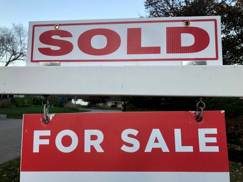 Real estate sale signage is shown on a street in Oakville, Ont., west of Toronto, on Thursday, Nov. 7, 2024. THE CANADIAN PRESS/Richard Buchan