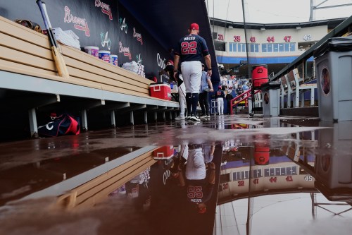 Atlanta Braves manager Walt Weiss (22) walks in the dugout during a rain delay before a spring training baseball game against the Minnesota Twins in North Port, Fla., Sunday, Feb. 22, 2026. (AP Photo/Gerald Herbert)