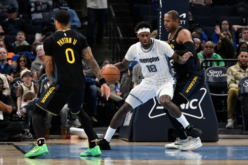 Memphis Grizzlies forward Olivier-Maxence Prosper (18) handles the ball between Golden State Warriors center Al Horford, right, and guard Gary Payton II (0) in the first half of an NBA basketball game, Wednesday, Feb. 25, 2026, in Memphis, Tenn. (AP Photo/Brandon Dill)