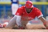 Canada's Denzel Clarke slides head first into third base on a single by Tyler Black off Toronto Blue Jays pitcher Angel Bastardo during the third inning of an exhibition baseball game Tuesday, March 3, 2026, in Dunedin, Fla. (AP Photo/Chris O'Meara)