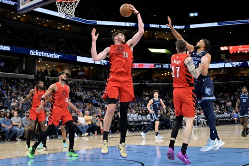 Portland Trail Blazers center Donovan Clingan (23) grabs a rebound in the first half of an NBA basketball game against the Memphis Grizzlies Wednesday, March 4, 2026, in Memphis, Tenn. (AP Photo/Brandon Dill)