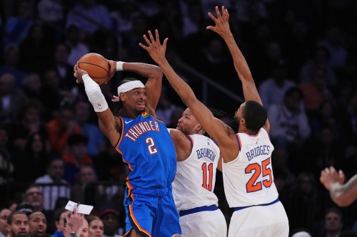 Oklahoma City Thunder's Shai Gilgeous-Alexander (2) protects the ball from New York Knicks' Jalen Brunson (11) and Mikal Bridges (25) during the second half of an NBA basketball game Wednesday, March 4, 2026, in New York. (AP Photo/Frank Franklin II)