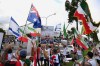 Iranians in Australia react with flags and political signs outside the stadium ahead of the Women's Asia Cup soccer match between Australia and Iran in Robina, Australia, Thursday, March 5, 2026. (Dave Hunt/AAPImage via AP)