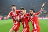 Bayern Munich's Joshua Kimmich, centre, celebrates with Josip Stanisic and Michael Olise after scoring his side's third goal during the Bundesliga soccer match between Borussia Dortmund and FC Bayern Munich in Dortmund, Germany, Saturday Feb. 28, 2026. (Federico Gambarini/dpa via AP)