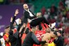 FILE - Morocco's head coach Walid Regragui is thrown in the air by players after the World Cup quarterfinal soccer match between Morocco and Portugal, at Al Thumama Stadium in Doha, Qatar, Saturday, Dec. 10, 2022. (AP Photo/Martin Meissner, File)