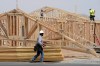 FILE - Construction workers install a lumber roof at a new home build Tuesday, April 1, 2025, in Laveen, Ariz. (AP Photo/Ross D. Franklin, File)