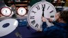 FILE - Ian Roders fastens the hands to a clock at Electric Time Company, Tuesday, Nov. 1, 2022, in Medfield, Mass. (AP Photo/Charles Krupa, file)
