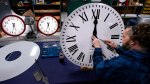 FILE - Ian Roders fastens the hands to a clock at Electric Time Company, Tuesday, Nov. 1, 2022, in Medfield, Mass. (AP Photo/Charles Krupa, file)