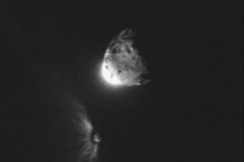 In this image provided by NASA, an impact plume emerges from the asteroid Dimorphos, left, after DART collides into it on Sept. 26, 2022, orbiting the larger asteroid Dimorphos. (NASA/ASI/University of Maryland/Tony Farnham/Nathan Marder via AP)