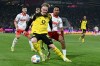 Cologne's Youssoupha Niang, right, and Dortmund's Julian Brandt fight for the ball during a German Bundesliga soccer match between 1.FC Koeln and Borussia Dortmund in Cologne, Germany, Saturday, March 7, 2026. (Federico Gambarini/dpa via AP)