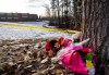 A small memorial of flowers rests down the path from the school where a mass shooting took place in Tumbler Ridge, B.C., on Thursday, Feb. 12, 2026. THE CANADIAN PRESS/Christinne Muschi