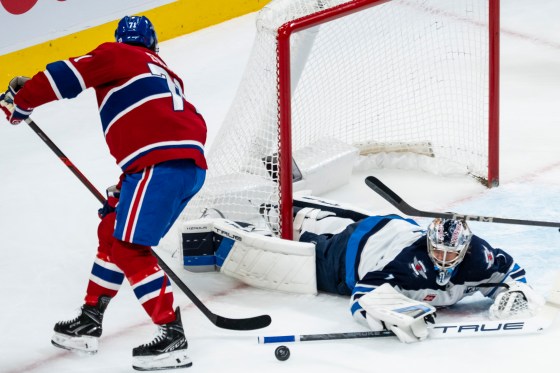 Winnipeg Jets goalie Eric Comrie (1) makes a save on Montreal Canadiens' Jake Evans (71) during their last matchup in Montreal on Dec. 3, 2025. (Christopher Katsarov / The Canadian Press files)