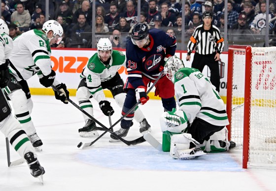 Winnipeg Jets' Gabriel Vilardi (13) tries to control a bouncing puck in front of Dallas Stars goaltender Casey DeSmith (1) as Brendan Smith (2) and Miro Heiskanen (4) defend during the Dec. 9, 2025 game in Winnipeg.  (Fred Greenslade / The Canadian Press files)